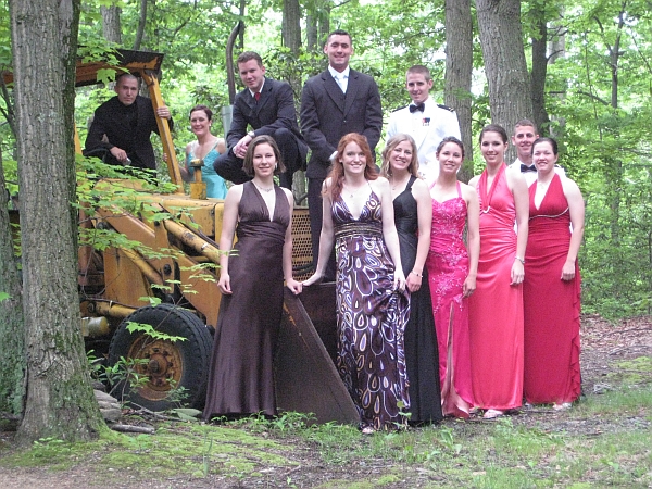 Kristen and friends taking photo op by the backhoe